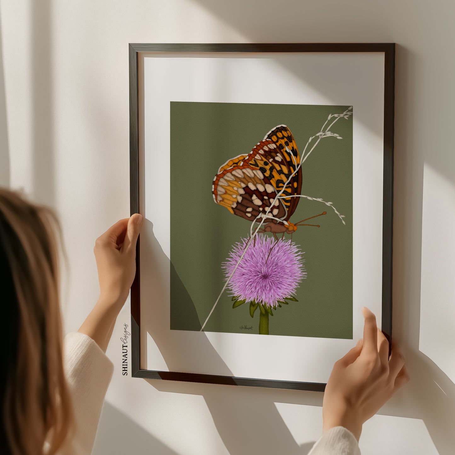 butterfly thistle art print with hands holding frame