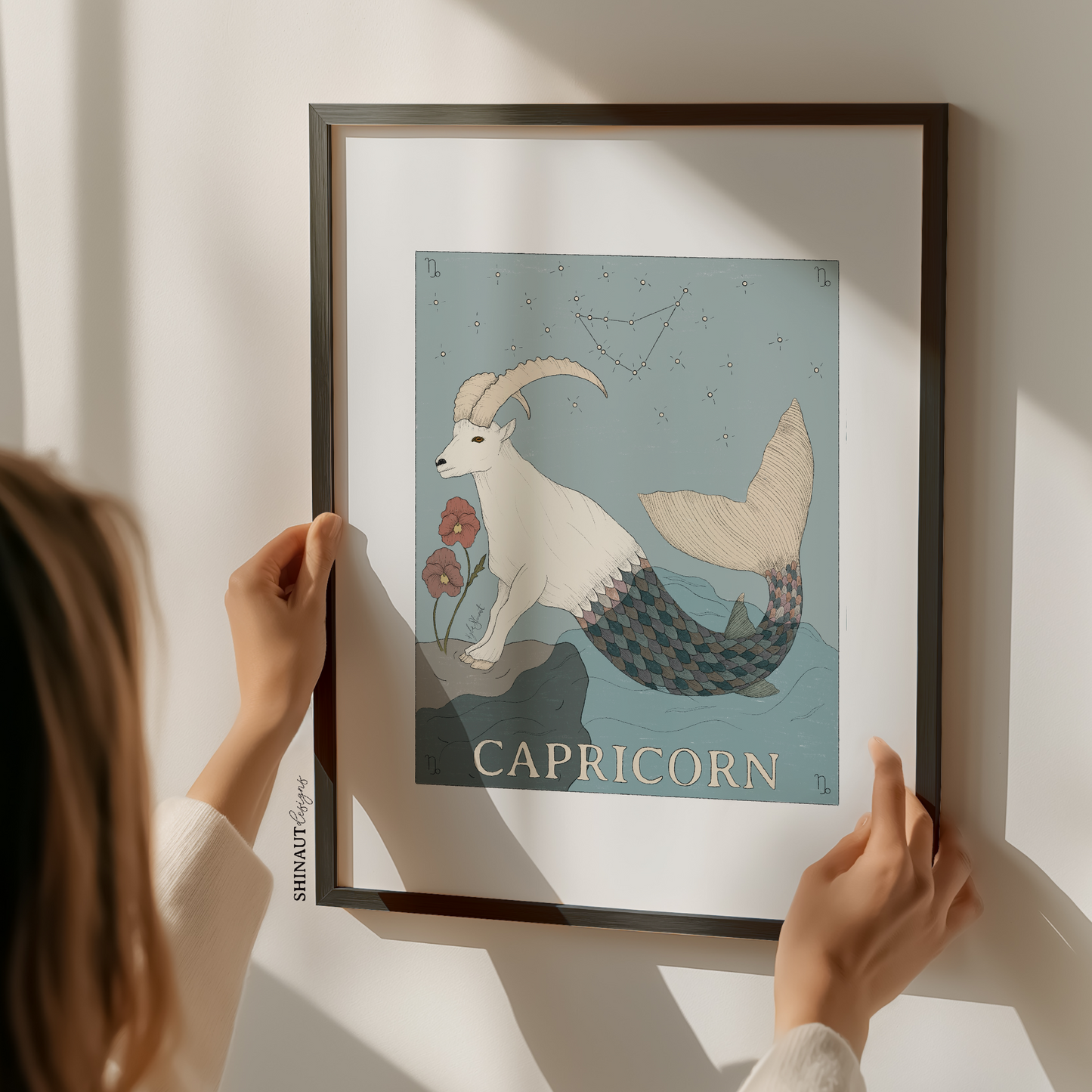capricorn zodiac art print with woman holding frame