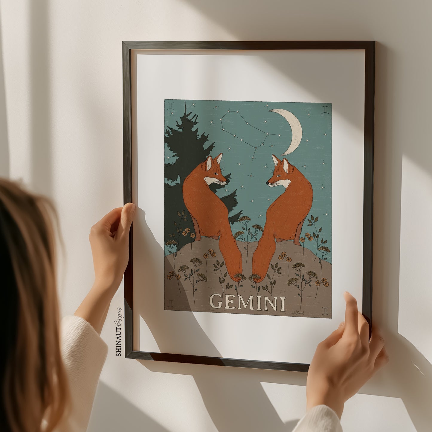 gemini zodiac art print with woman holding frame