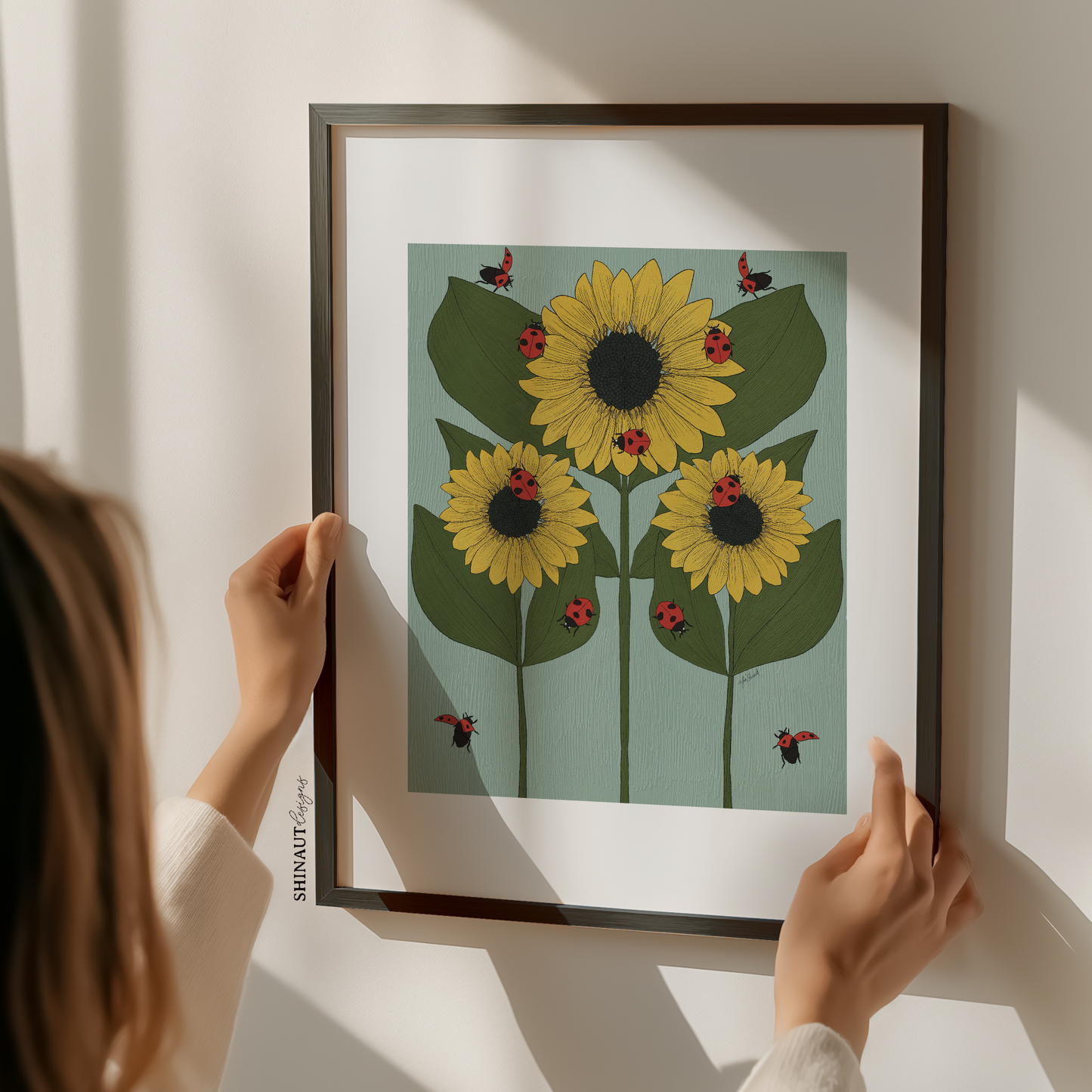 sunflowers and ladybugs nouveau art print with woman holding frame