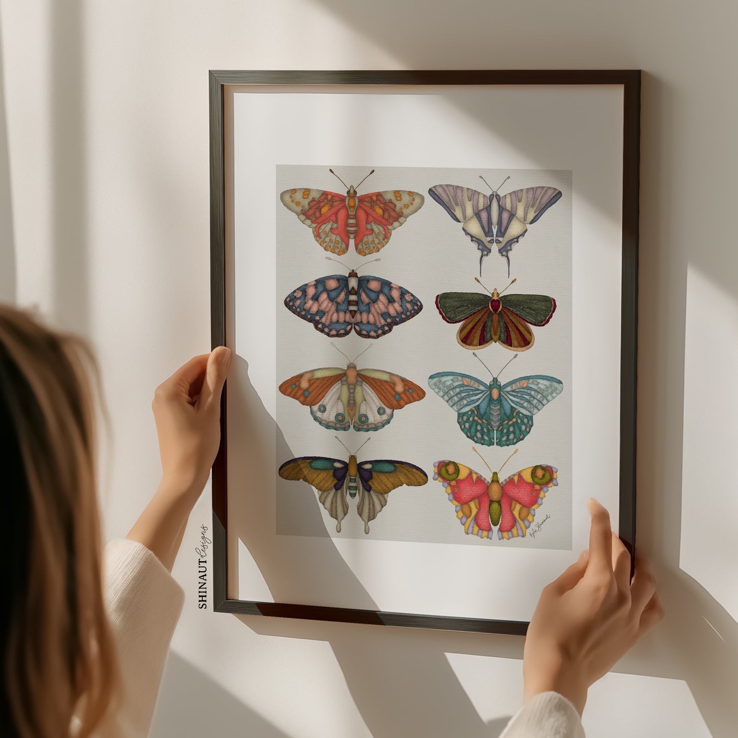 garden butterflies art print with hands holding frame