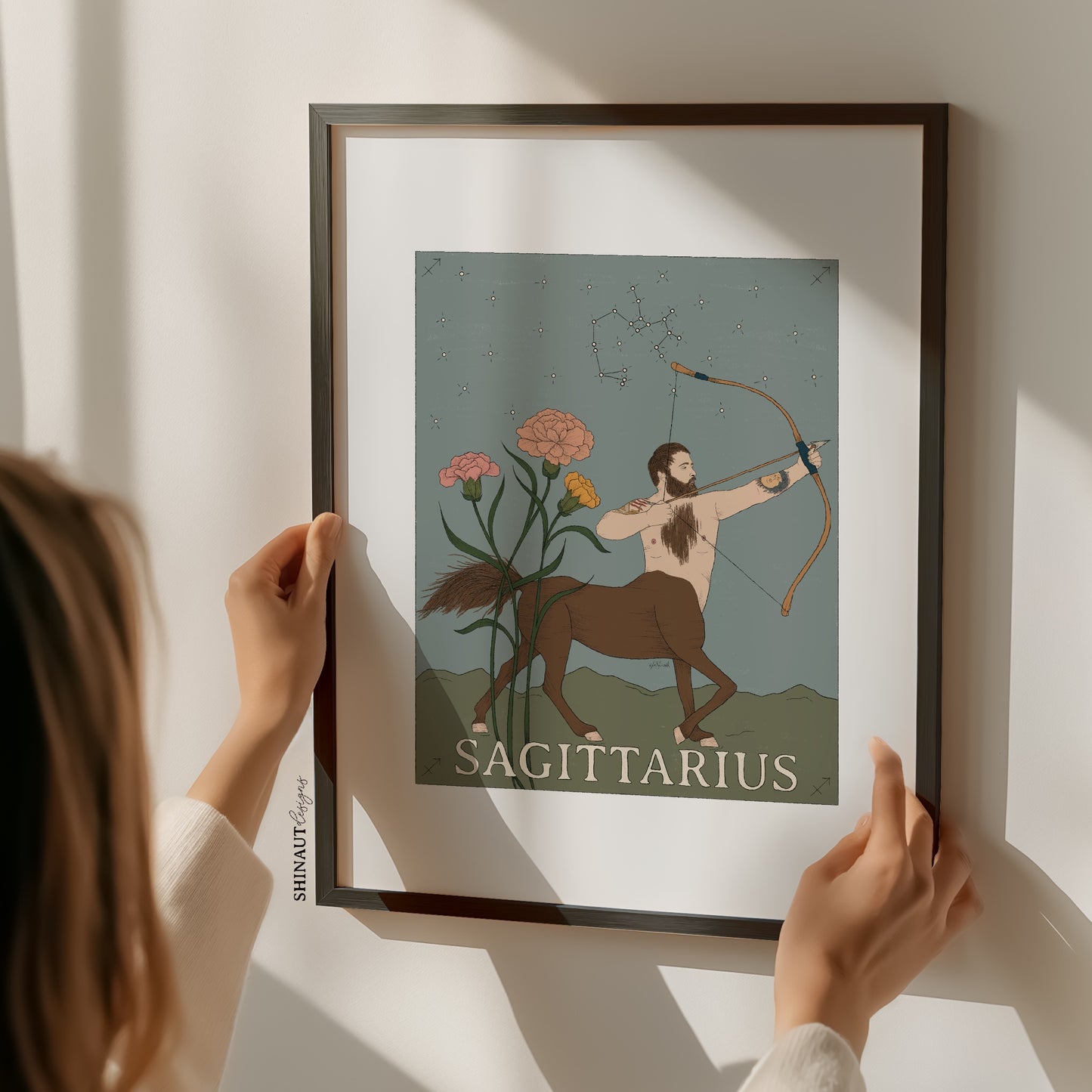 sagittarius zodiac art print with woman holding frame